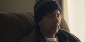 Movie still from “Paddleton” (2019), directed by Alex Lehmann – An older man wearing glasses and wearing a hat; Close Up shot, Over the shoulder angle