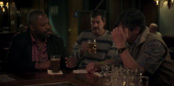 Movie still from “Paddleton” (2019), directed by Alex Lehmann – A group of people sitting at a table drinking beer; Medium shot, Over the shoulder angle