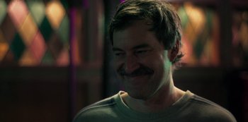 Movie still from “Paddleton” (2019), directed by Alex Lehmann – A person with a mustache smiling; Close Up shot, Over the shoulder angle