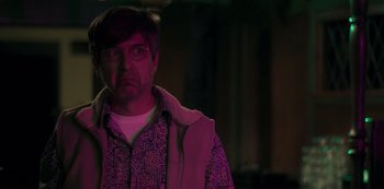 Movie still from “Paddleton” (2019), directed by Alex Lehmann – A man in a purple jacket looking at the camera; Close Up shot, Over the shoulder angle