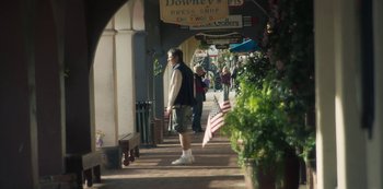 Movie still from “Paddleton” (2019), directed by Alex Lehmann – A man walking down the sidewalk of a city street; Wide shot, High angle