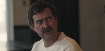 Movie still from “Paddleton” (2019), directed by Alex Lehmann – A person with a mustache; Close Up shot, Over the shoulder angle