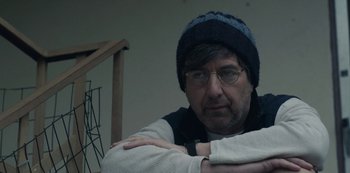 Movie still from “Paddleton” (2019), directed by Alex Lehmann – A man wearing glasses and wearing a hat; Close Up shot, Over the shoulder angle