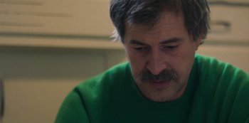 Movie still from “Paddleton” (2019), directed by Alex Lehmann – A person wearing a green shirt; Close Up shot, Over the shoulder angle