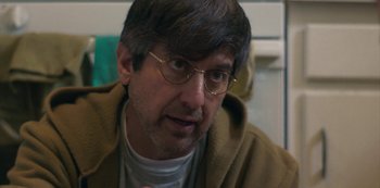 Movie still from “Paddleton” (2019), directed by Alex Lehmann – A person wearing glasses and a jacket; Close Up shot, Over the shoulder angle