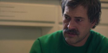 Movie still from “Paddleton” (2019), directed by Alex Lehmann – A person wearing a green shirt; Close Up shot, Over the shoulder angle
