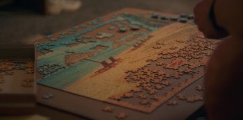 Movie still from “Paddleton” (2019), directed by Alex Lehmann – A puzzle is shown on a table with pieces missing; Extreme Close Up shot, High angle