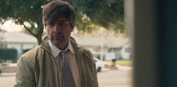 Movie still from “Paddleton” (2019), directed by Alex Lehmann – A man in a tan jacket and a striped tie; Close Up shot, Over the shoulder angle
