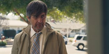 Movie still from “Paddleton” (2019), directed by Alex Lehmann – A person wearing a jacket and a tie; Close Up shot, Over the shoulder angle