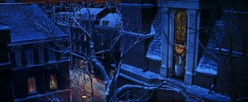 Movie still from “Peter Pan” (2003), directed by P.J. Hogan – A view of a building from a window at night; Extreme Wide shot, High angle