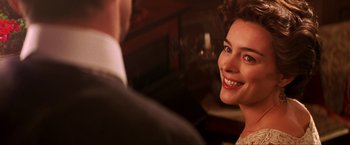 Movie still from “Peter Pan” (2003), directed by P.J. Hogan – A woman smiling at a man in a suit; Close Up shot, Over the shoulder angle