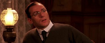 Movie still from “Peter Pan” (2003), directed by P.J. Hogan – A person wearing glasses and a tie; Close Up shot, Low angle