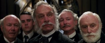 Movie still from “Peter Pan” (2003), directed by P.J. Hogan – A group of men standing next to each other in a room; Close Up shot, Low angle