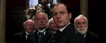 Movie still from “Peter Pan” (2003), directed by P.J. Hogan – A group of men standing next to each other in a room; Close Up shot, Low angle