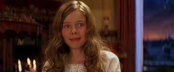 Movie still from “Peter Pan” (2003), directed by P.J. Hogan – A young girl with long blonde hair wearing a white dress; Close Up shot, High angle