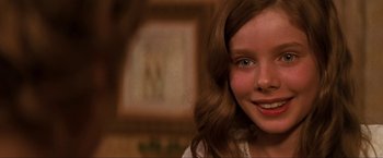 Movie still from “Peter Pan” (2003), directed by P.J. Hogan – A young girl smiling for the camera; Close Up shot, Over the shoulder angle
