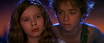 Movie still from “Peter Pan” (2003), directed by P.J. Hogan – A boy and a girl are looking at the camera; Close Up shot, Low angle