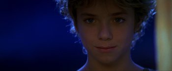 Movie still from “Peter Pan” (2003), directed by P.J. Hogan – A young boy's face in the dark; Close Up shot, Over the shoulder angle