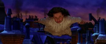 Movie still from “Peter Pan” (2003), directed by P.J. Hogan – A girl is flying through the air in front of a purple sky; Medium shot, Low angle