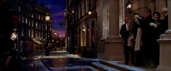 Movie still from “Peter Pan” (2003), directed by P.J. Hogan – A city street at night lit by street lights; Wide shot, Low angle