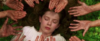 Movie still from “Peter Pan” (2003), directed by P.J. Hogan – A young girl laying in the middle of a group of hands; Close Up shot, Overhead angle