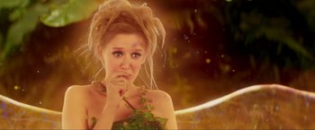 Movie still from “Peter Pan” (2003), directed by P.J. Hogan – A beautiful young lady wearing a green dress and holding her hand to her face; Medium shot, Over the shoulder angle