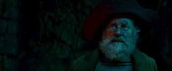 Movie still from “Peter Pan” (2003), directed by P.J. Hogan – An old man with a beard wearing a red hat; Close Up shot, Low angle