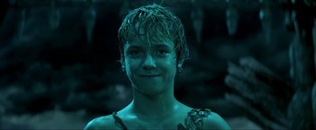 Movie still from “Peter Pan” (2003), directed by P.J. Hogan – A young boy with wet hair and a green shirt; Close Up shot, Low angle