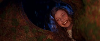 Movie still from “Peter Pan” (2003), directed by P.J. Hogan – A young girl smiling while sitting in a tree; Close Up shot, Low angle