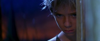 Movie still from “Peter Pan” (2003), directed by P.J. Hogan – A person's face in a dark room; Close Up shot, Over the shoulder angle