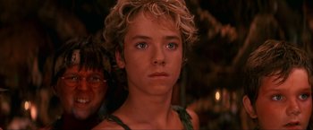 Movie still from “Peter Pan” (2003), directed by P.J. Hogan – A person with short blond hair; Close Up shot, Over the shoulder angle