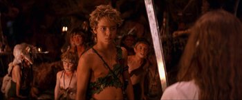 Movie still from “Peter Pan” (2003), directed by P.J. Hogan – A group of young people standing in a room; Medium shot, Over the shoulder angle