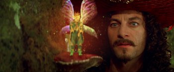 Movie still from “Peter Pan” (2003), directed by P.J. Hogan – A man's face and a fairy figurine; Close Up shot, Over the shoulder angle