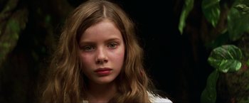 Movie still from “Peter Pan” (2003), directed by P.J. Hogan – A young girl with long brown hair stares into the camera; Close Up shot, Over the shoulder angle