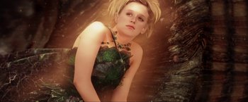 Movie still from “Peter Pan” (2003), directed by P.J. Hogan – A woman with blonde hair wearing a green dress; Medium shot, Overhead angle