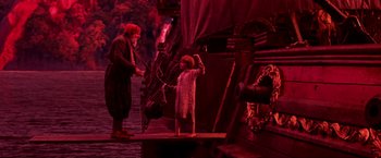 Movie still from “Peter Pan” (2003), directed by P.J. Hogan – A young boy holding an umbrella standing next to an older man; Wide shot, High angle