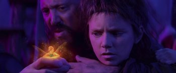 Movie still from “Peter Pan” (2003), directed by P.J. Hogan – A man and a woman looking at a glowing object in the dark; Close Up shot, Over the shoulder angle