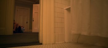 Movie still from “Ratched” (2020), created by Evan Romansky – A bathroom with a door open to a toilet; Wide shot, High angle
