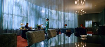 Movie still from “Ratched” (2020), created by Evan Romansky – A person standing in front of a dining room table; Wide shot, Low angle