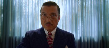 Movie still from “Ratched” (2020), created by Evan Romansky – An older man wearing a suit and tie; Close Up shot, Low angle