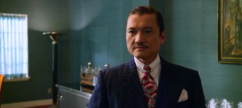 Movie still from “Ratched” (2020), created by Evan Romansky – A person wearing a suit and a tie; Close Up shot, Low angle