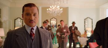 Movie still from “Ratched” (2020), created by Evan Romansky – A group of men in suits and ties in a room; Medium shot, Low angle