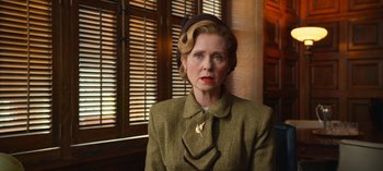 Movie still from “Ratched” (2020), created by Evan Romansky – An older woman wearing a hat and a suit; Medium shot, Over the shoulder angle