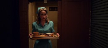 Movie still from “Ratched” (2020), created by Evan Romansky – A woman holding a tray with food on top of it; Medium shot, Low angle