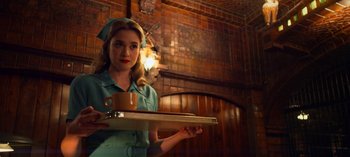 Movie still from “Ratched” (2020), created by Evan Romansky – A woman holding a tray with a cup of coffee on top of it; Medium shot, Low angle