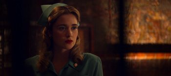 Movie still from “Ratched” (2020), created by Evan Romansky – A woman with a green shirt and a white hat; Close Up shot, Over the shoulder angle