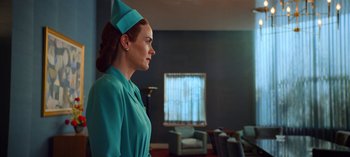 Movie still from “Ratched” (2020), created by Evan Romansky – A woman wearing a green dress and a hat; Medium shot, Low angle