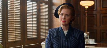 Movie still from “Ratched” (2020), created by Evan Romansky – An older woman wearing a blue suit and hat; Medium shot, Over the shoulder angle