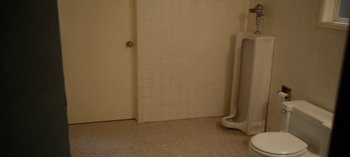 Movie still from “Ratched” (2020), created by Evan Romansky – A bathroom that has white tile on the walls; Wide shot, High angle