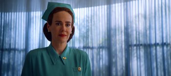 Movie still from “Ratched” (2020), created by Evan Romansky – A woman wearing a green uniform and a hat; Close Up shot, Low angle
